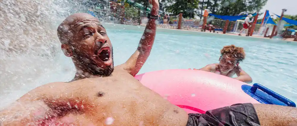 dad-and-son-in-pool Son splashing his Dad in the wave pool